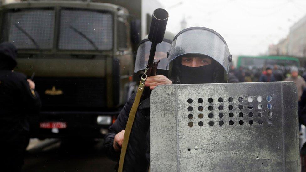 A police officer holds a tear gas rifle during an opposition rally in Minsk, Belarus (March 25, 2017)