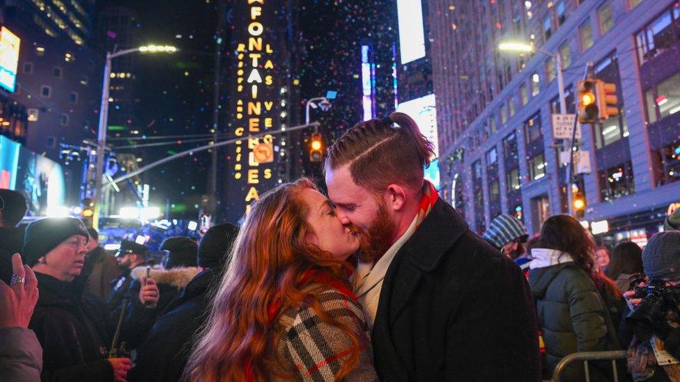 Matt Lutz and Olivia Shain, from Owensville Indiana, kiss amongst the ticker tape in New York