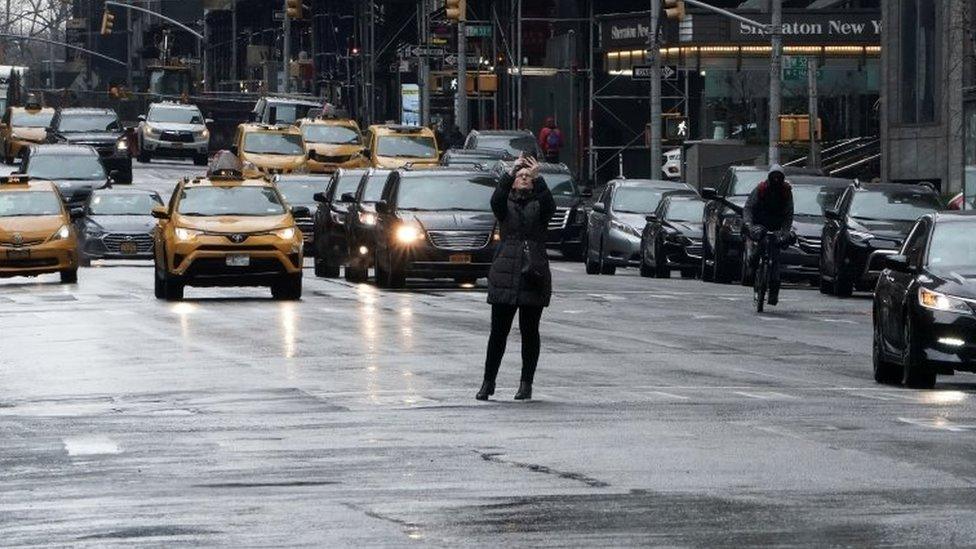 A woman takes a picture on New York's Times Square. File photo