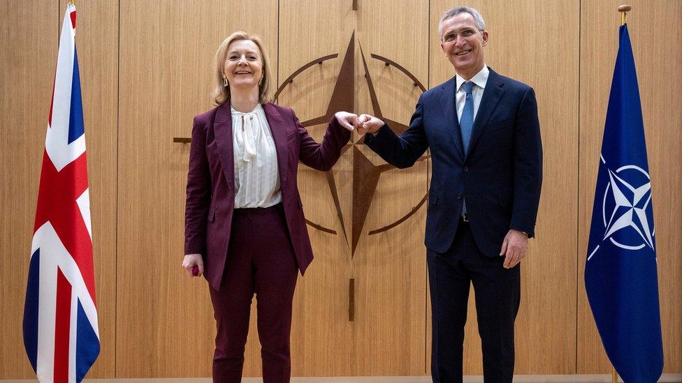 Nato Secretary General Jens Stoltenberg (R) greets British Foreign Secretary Liz Truss