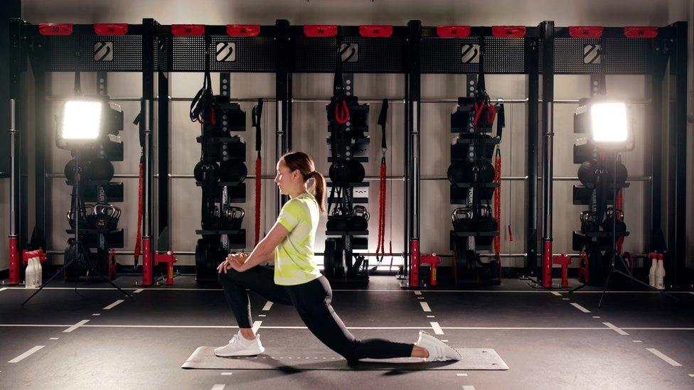 Jessica Ennis Hill stretching in the gym