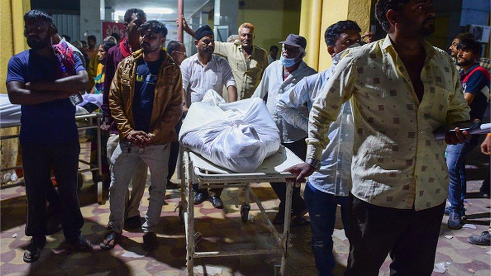 A body is claimed from the morgue of the government civil hospital after a bridge across the river Machchhu collapsed in Morbi, some 220 kms from Ahmedabad, early on October 31, 2022.