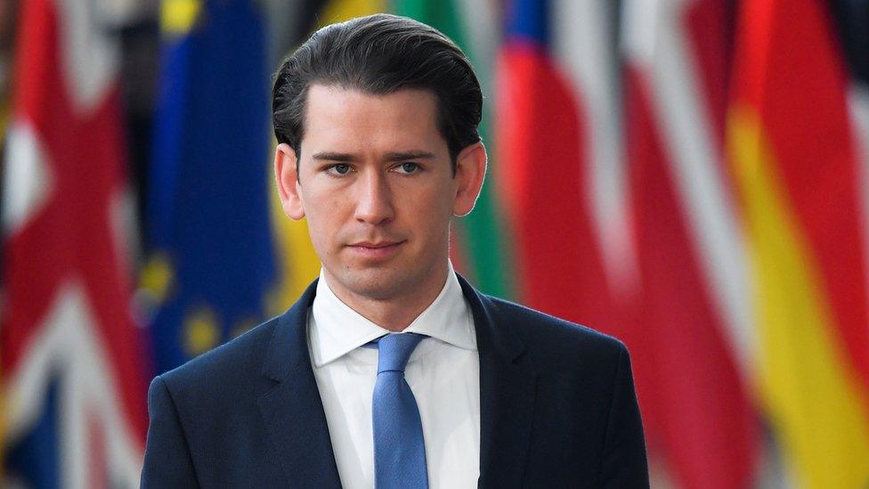 Austrian Chancellor Sebastian Kurz walks in front of flags from European nations at an EU summit in March 2019