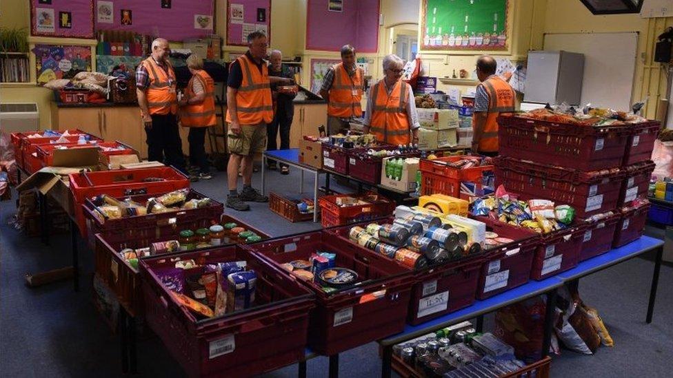 Volunteers with food to give to returning residents