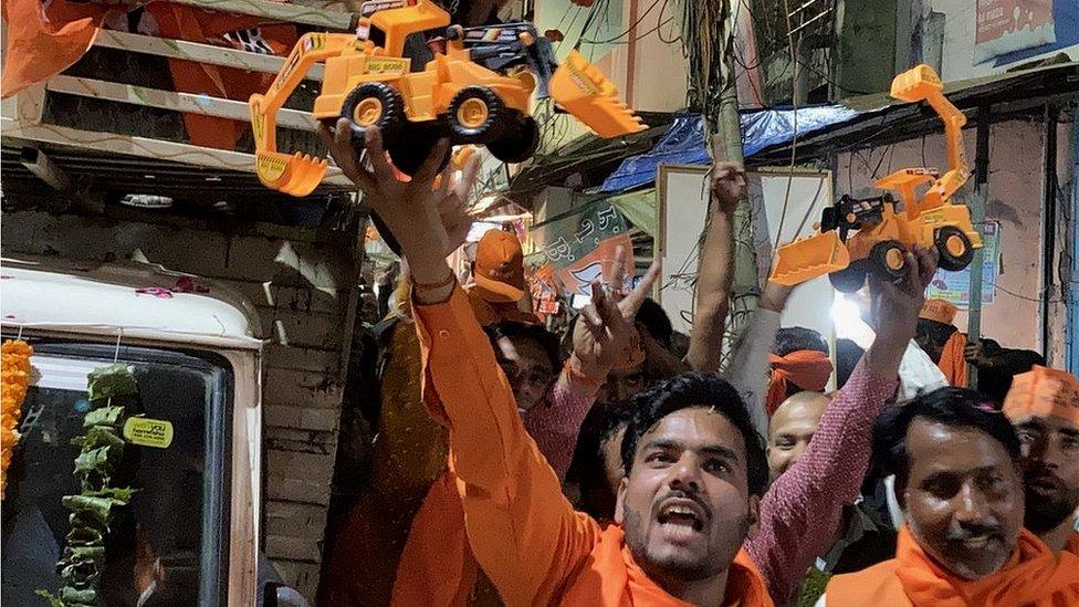 Yogi Adityanath's supporters with toy bulldozers