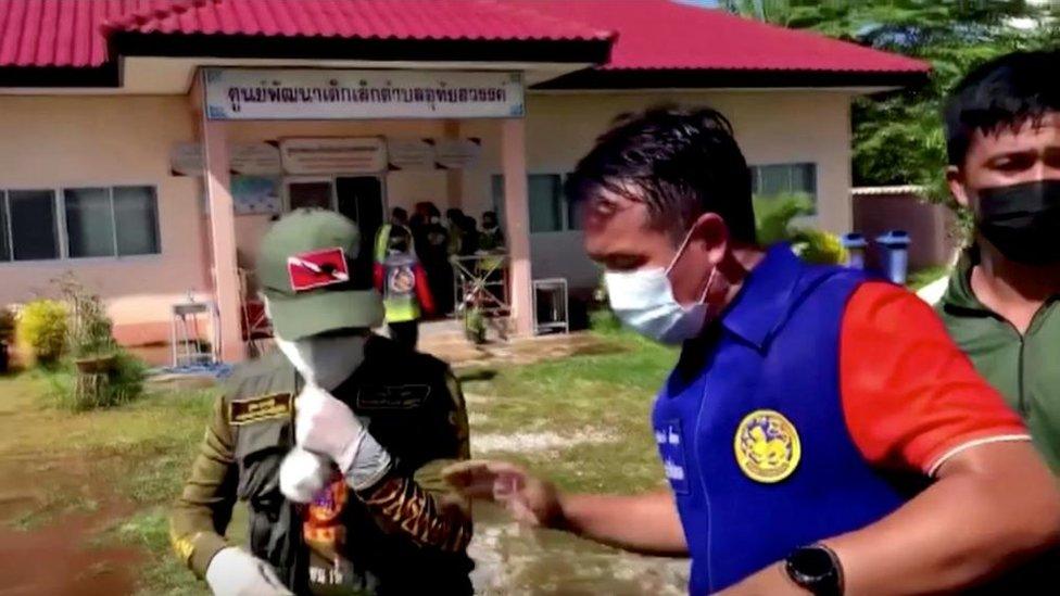 Officials and authorities guard the gate of daycare centre, 6 October 2022