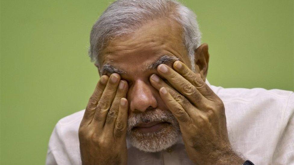 India's Prime Minister Narendra Modi rubs his eye as he attends a conference by the environment ministry in New Delhi, India. Modi"s ruling Hindu nationalist party conceded defeat Sunday in a crucial election in Bihar, one of India"s most populous states.