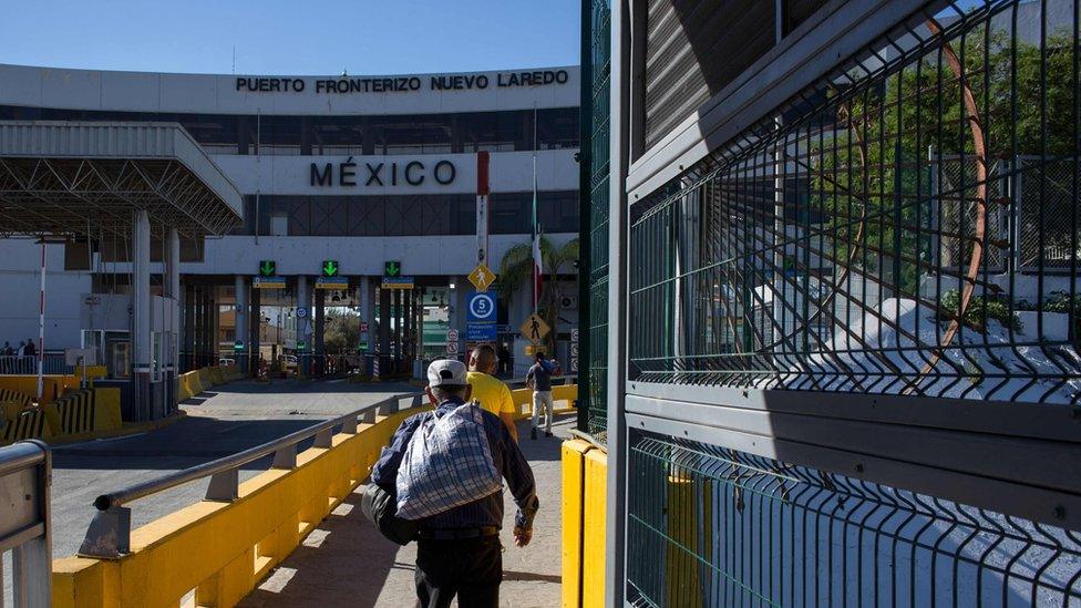 A man walks to Mexico after crossing the international bridge on the US/Mexico border in Nuevo Laredo
