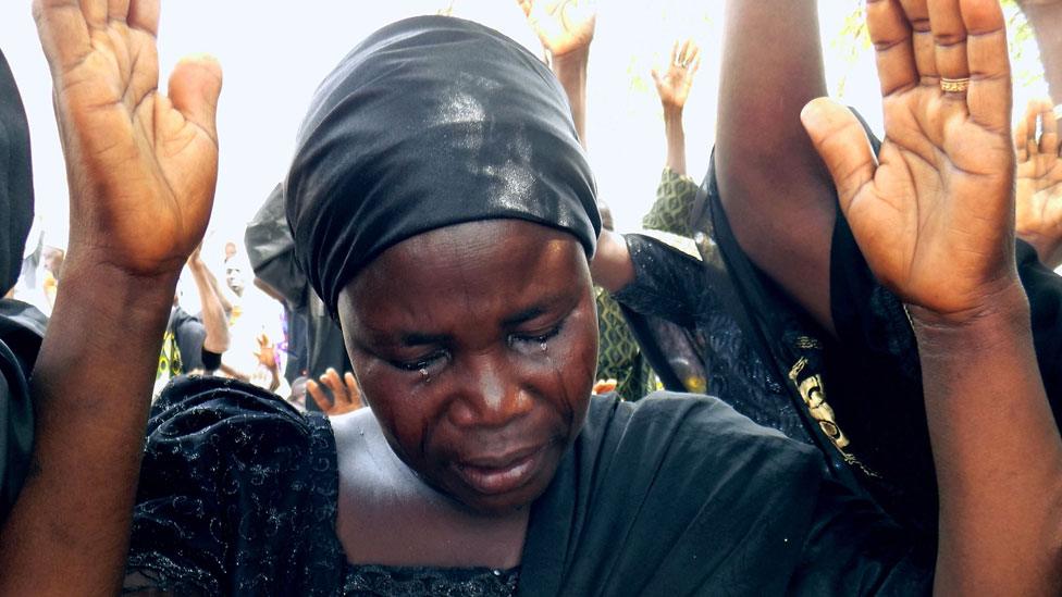 Bintu Bitrus, the mother of Godiya, one of the missing Chibok schoolgirls, weeps as she raises her hands along with other parents to pray for the release of their daughters kidnapped by Boko Haram jihadists, during a worship service to mark the fourth anniversay of the kidnapping at Chibok Town, Borno State, on April 14, 2018