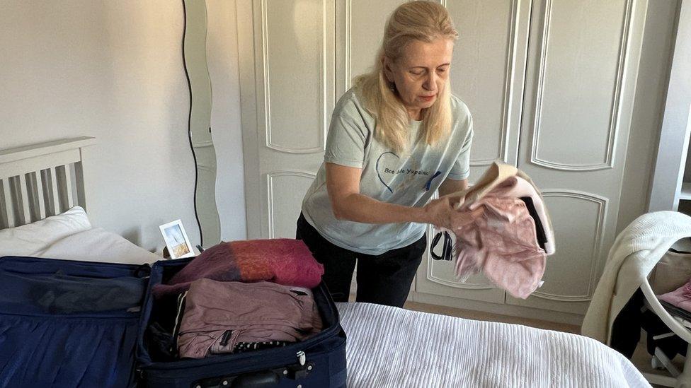 Oksana Petrova, from Ukraine, unpacking her suitcase