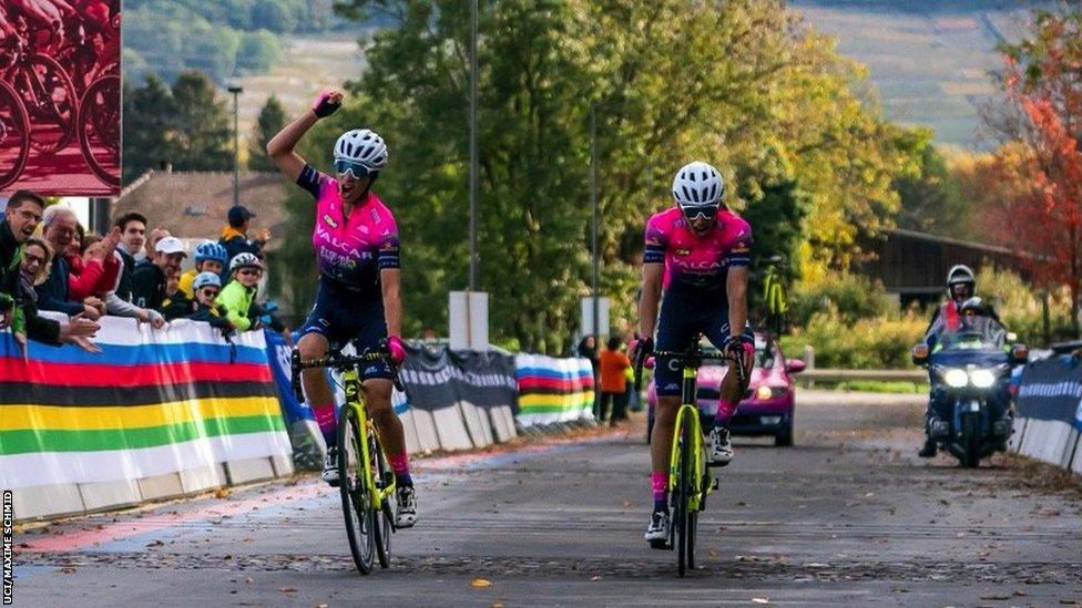 Two cyclists celebrating at the finish line