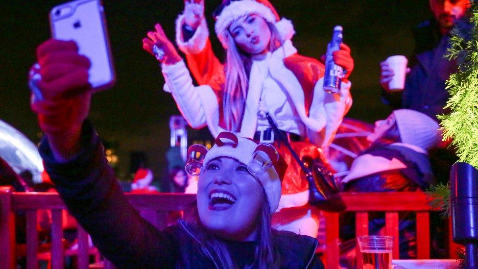 Revellers take a selfie in the annual SantaCon event in Manhattan, New York, December 10, 2016.