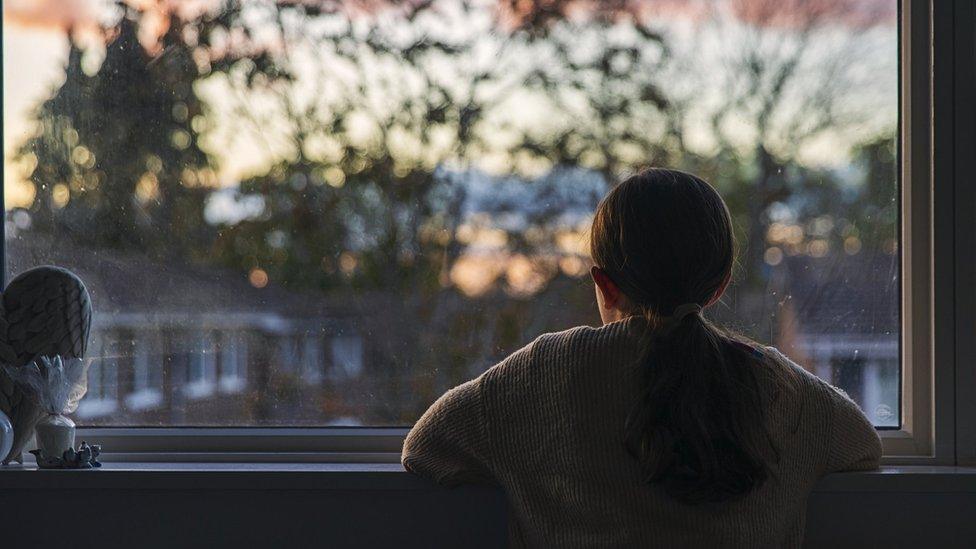 girl looking out window