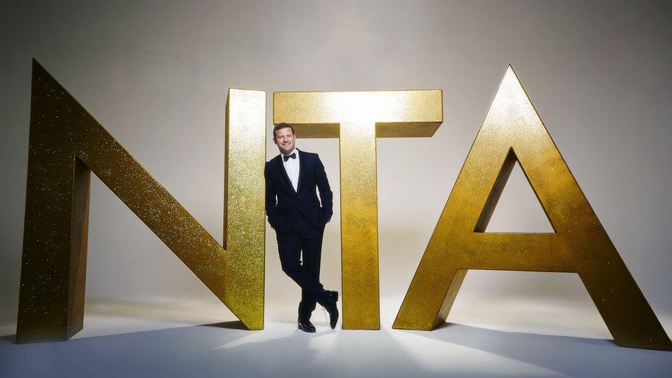 Dermot O'Leary leans against NTA