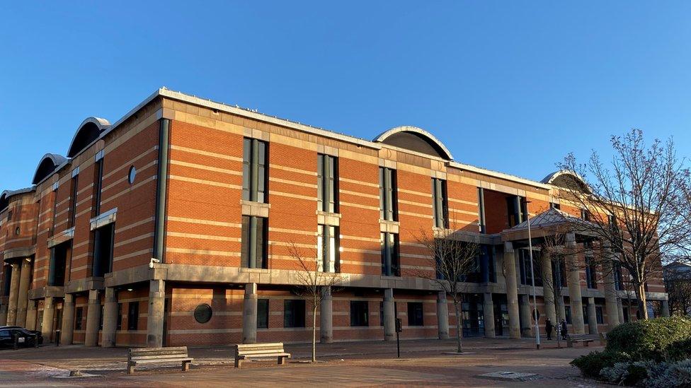 A large red brick court building