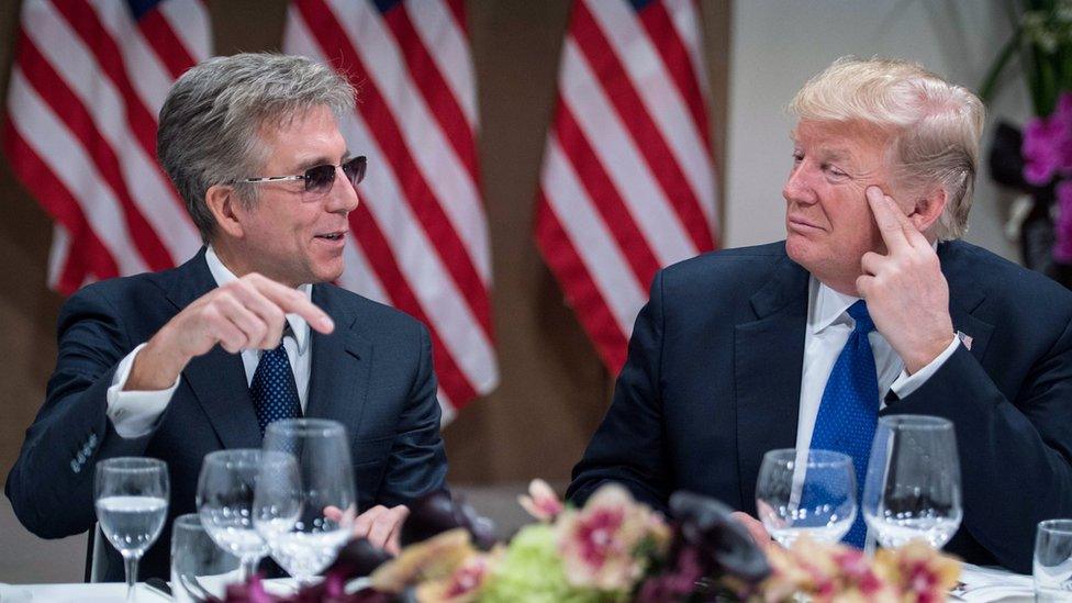 US President Donald Trump (R) listens to SAP CEO Bill McDermott during a working dinner with European business leaders during the World Economic Forum (WEF) annual meeting in Davos, eastern Switzerland, on January 25, 2018.