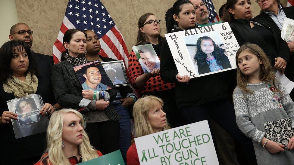 Sandy Hook families hold pictures of their loved ones