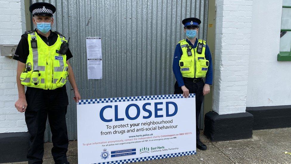 Hertfordshire Police officers outside a closed industrial unit.