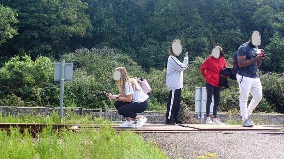 Teenager in Harlech pose for selfies on a level crossing