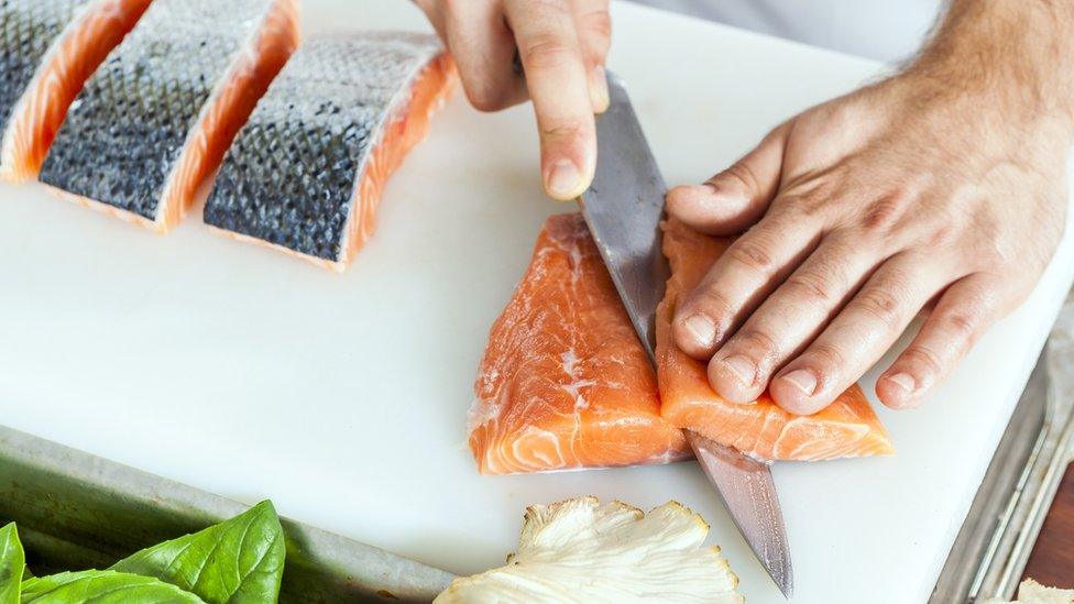 Cutting raw salmon