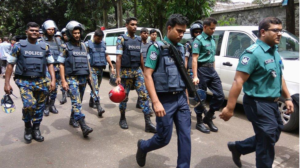 Security personnel are seen near the Holey Artisan restaurant hostage site, in Dhaka, Bangladesh, 2 July 2016.