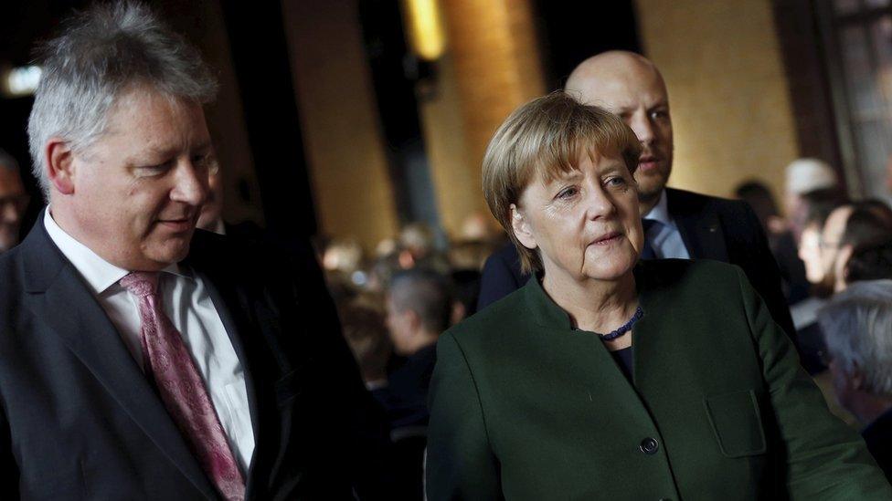 German Chancellor Angela Merkel, right, and the President of the German Federal Intelligence Agency (BND) Bruno Kahl at a ceremony on 28 Nov