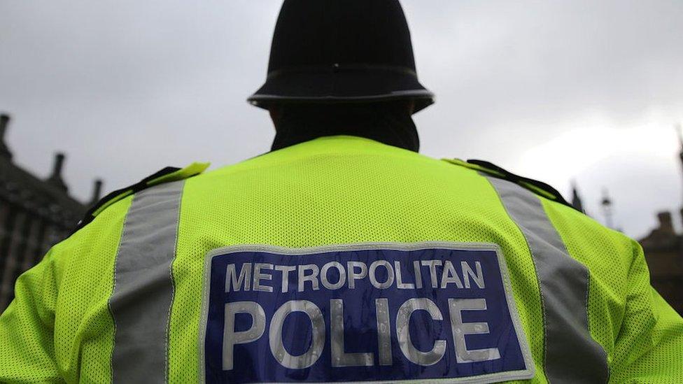 Met Police officer, back of reflective jacket reading "metropolitan police"