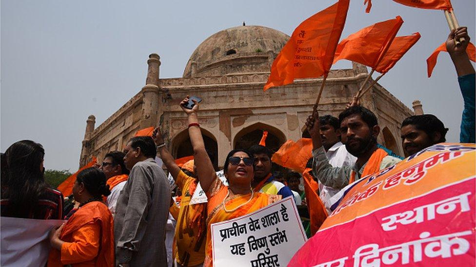 Members of Hindu organisations carry flags and recite Hanuman Chalisa outside the Qutub Minar demanding to rename the monument as 'Vishnu Stambh' on May 10, 2022 in New Delhi, India.