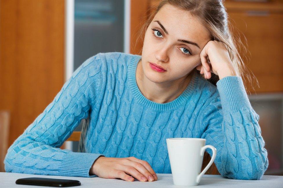 Bored woman waiting for call