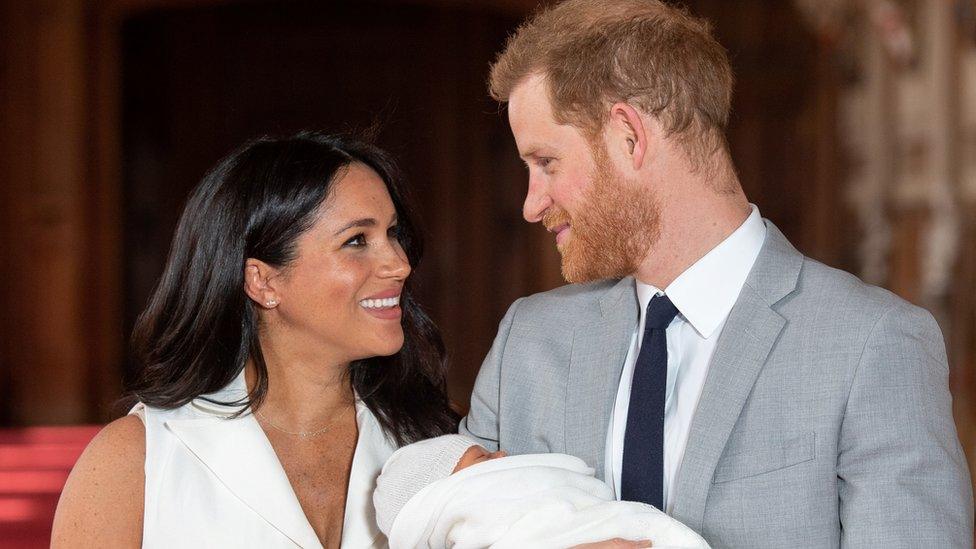 Britain"s Prince Harry and Meghan, Duchess of Sussex hold their baby son, who was born on Monday morning,