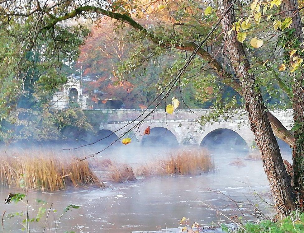 Mist over water by a bridge