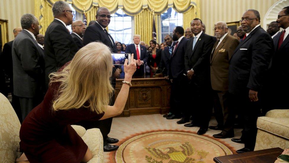 Kellyanne Conway takes a photo as US President Donald Trump meets leaders of historically black colleges and universities, 27 February 2017