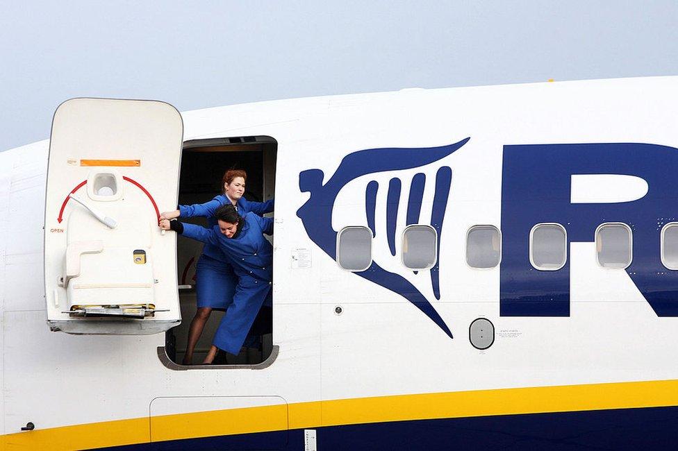 Ryanair flight attendants close the airplane door of a Boeing 737-800 at the Altenburg-Nobitz airport, eastern Germany 01 March 2007