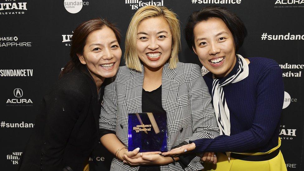 Producer Jane Zheng, director Cathy Yan, and producer Clarissa Zhang backatage after accepting the Special Jury Award for Ensemble Acting for their film Dead Pigs at Basin Recreation Field House on January 27, 2018 in Park City, Utah.