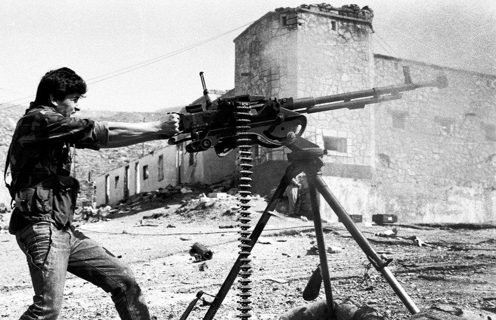 A fighter from the Kurdistan Front fires a heavy machine gun at an attacking Iraqi helicopter, northern Iraq