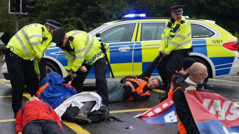 Police officers arrest protesters