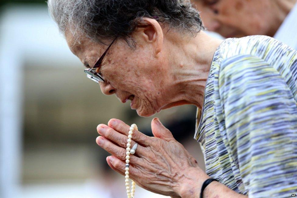 A woman cries as she offers prayers at the Peace Park before the 70th anniversary of the Nagasaki bombing - 9 August 2015