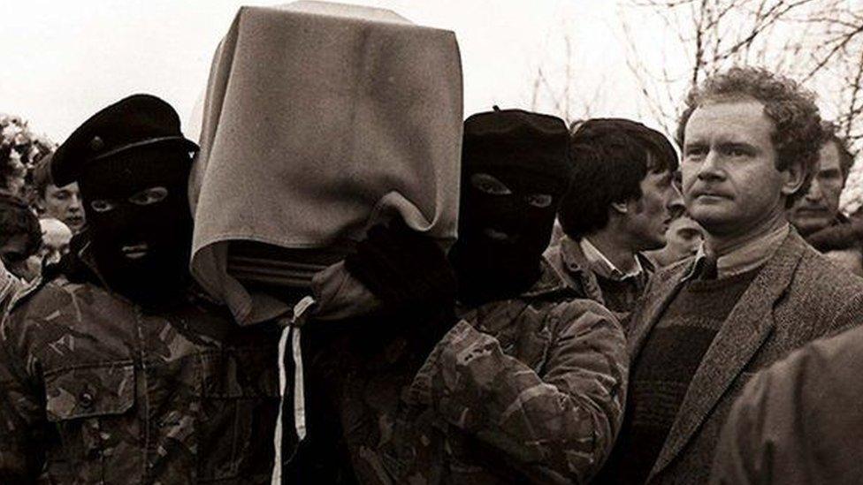 Martin McGuinness pictured with masked men at an IRA funeral in 1988