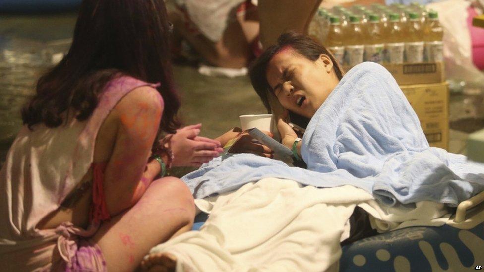A young woman winces in pain after the fire at the Taipei park, 27 June