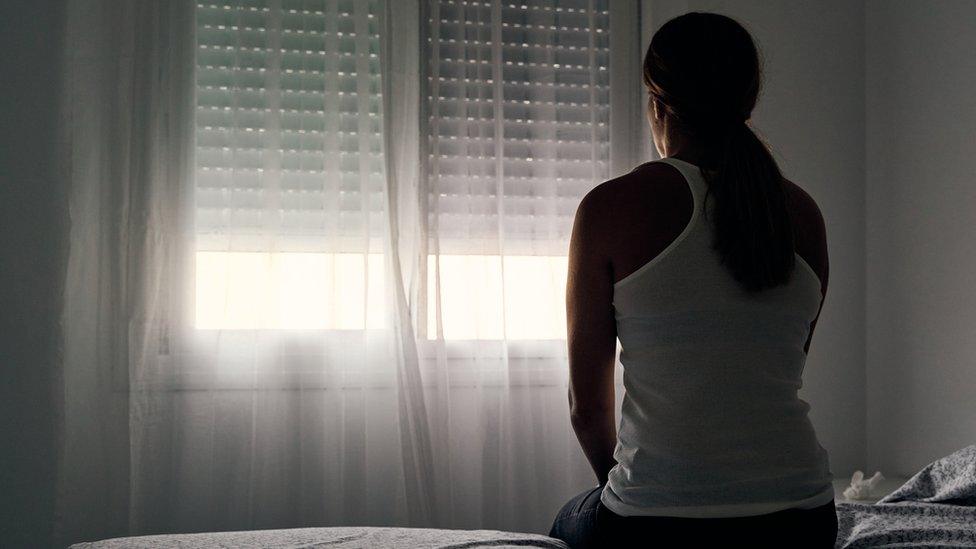 Woman alone in bedroom