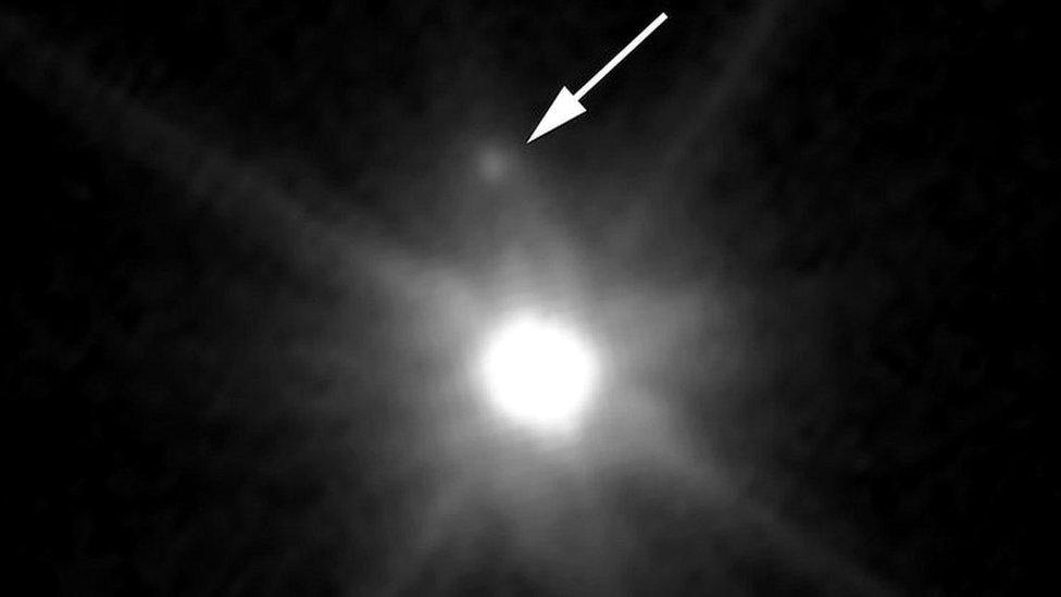 A picture showing the dwarf planet Makemake and its newly discovered moon