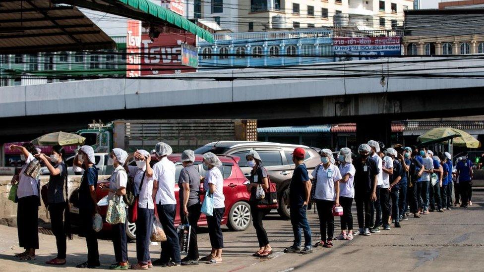 People queue to be tested for Covid-19 at a seafood market in Samut Sakhon on December 19, 2020