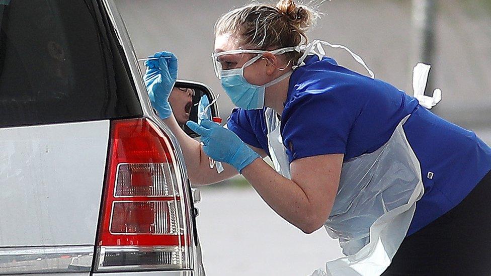 Medical staff at an NHS drive through coronavirus disease (COVID-19) testing facility in the car park of Chessington World of Adventures as the spread of the coronavirus disease (COVID-19) continues, Chessington,