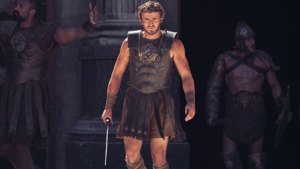 Paul Mescal in Gladiator II, pictured carrying a sword in the Colosseum