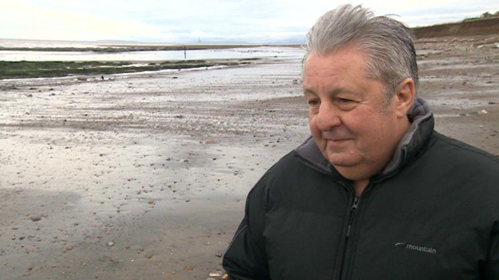 Dr Andy King standing on the beach at Doniford Bay