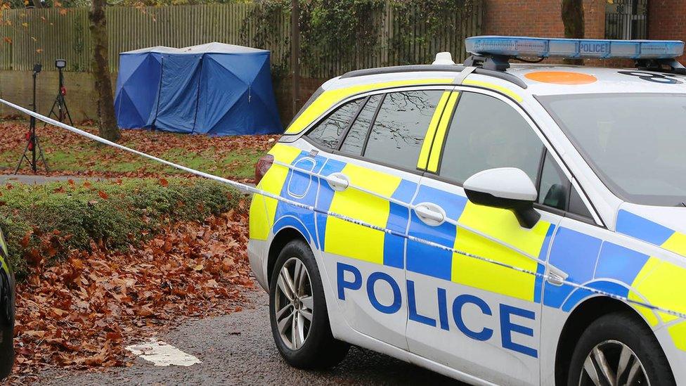 Forensics tent and police car