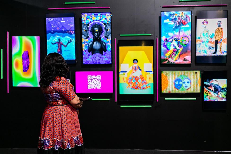 Woman looking at a wall of digital images