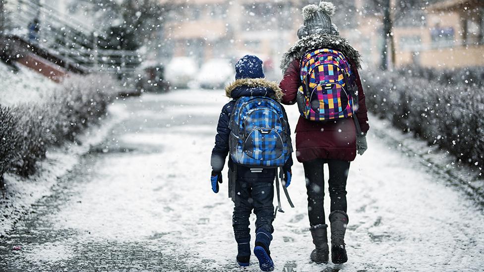 Children walk in snow