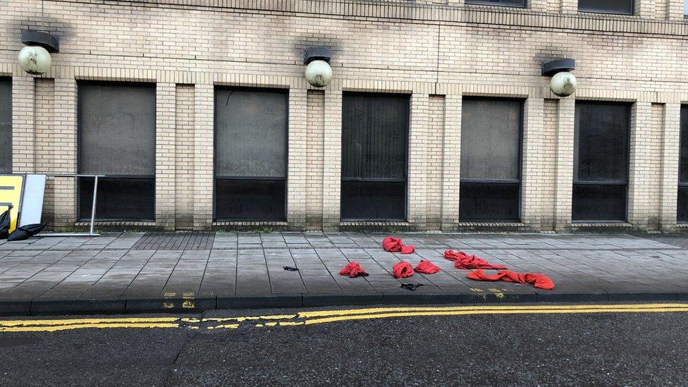 Santa costumes discarded on floor