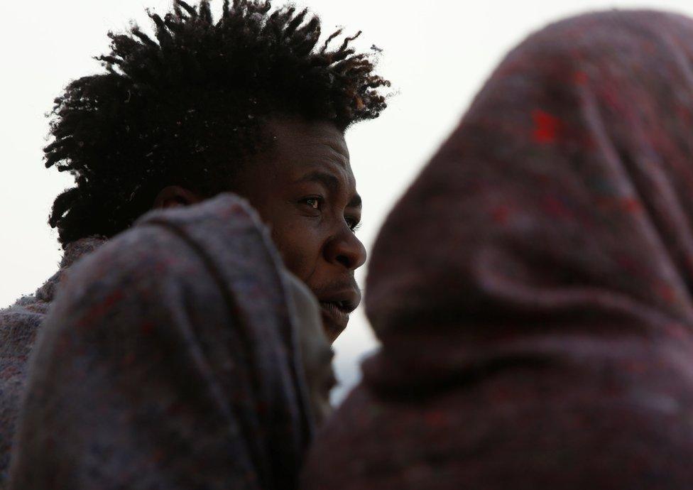 A migrant looks out towards the Maltese island of Gozo after a rescue operation off the coast of Libya
